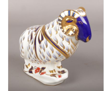 A Royal Crown Derby ceramic figure of a ram, silver stopper.  Minor chip to gilding on one horn and gilding on base.