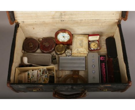 A suitcase of collectables to include military compass, pipes, cigarette cards, mother of pearl pill box, pin badges etc.  