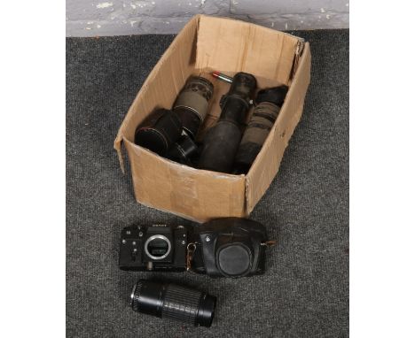 A box of camera equipment to include Zenit camera, Pentax camera, lenses etc.  