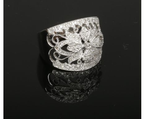 A 14ct white gold and diamond ring. With large open floriform panel set with diamonds in milgrain borders. 6.6 grams gross, s