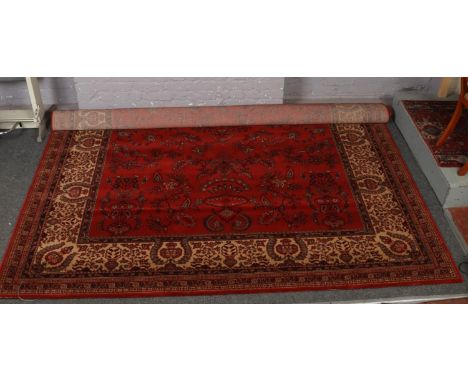 A red ground wool Super Taj carpet, with floral design.(366 x 274cm).  