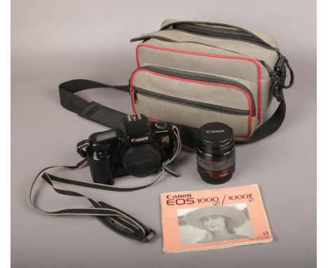 A Canon EOS 1000F 35mm SLR camera, along with a Canon EF 35mm-80mm lens and instruction manual.  