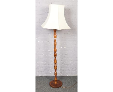 A wooden standard lamp with shade  