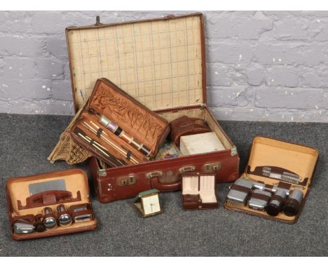 A vintage suitcase to include a collection of gentleman's sets in cases etc  