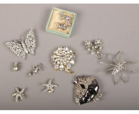 A case of vintage white paste costume jewellery including spider, butterfly and spray brooches.  