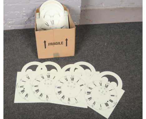 A box of metal and brass clock faces to include enamel examples.  