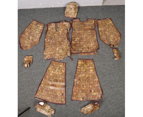 A Chinese Han Dynasty style jade coloured hardstone burial suit, the rectangular plaques joined by copper wire and edged by p