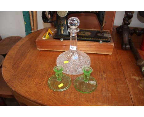 A Royal Doulton decanter and stopper with a pair of green glass candle sticks 