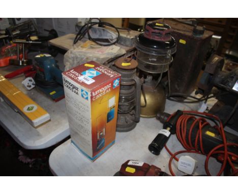 A Tilly lamp together with a Hurricane lamp and a camping gas lamp 