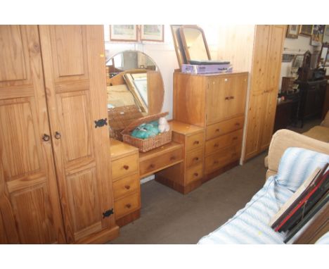 A light oak tall boy fitted three drawers together with a matching dressing table 