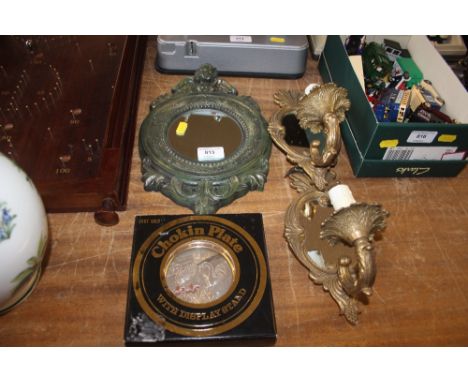 Two wall light fittings; a small mirror decorated with a cherub etc