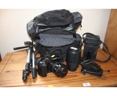 A camera bag and contents together with a Minolta camera; tripod; lenses etc