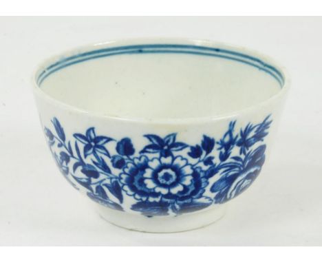 A WORCESTER TEA BOWL TRANSFER PRINTED WITH UNDERGLAZE BLUE WITH A THREE FLOWERS PATTERN, HATCHED CRESCENT, CIRCA 1780