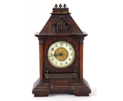 A 19TH CENTURY BRASS MOUNTED OAK ARCHITECTURAL CASED MANTLE CLOCK, THE TIMEPIECE WITH PRIMROSE ENAMEL CHAPTERING, 29CM H