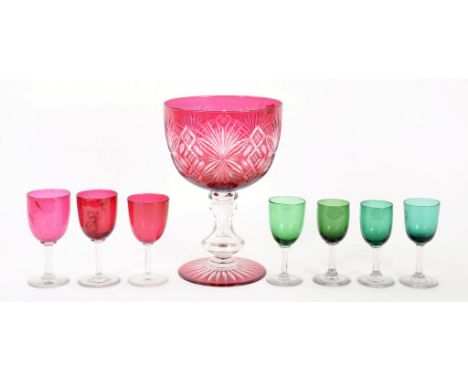 A RUBY FLASHED AND CUT GLASS MAMMOTH GOBLET, 26CM H, 19TH C (CHIP ON FOOT) AND SEVEN VICTORIAN CRANBERRY OR GREEN GLASS WINES