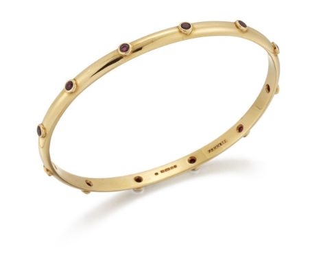 Theo Fennell, an 18ct gold and ruby bangle, inset with circular-cut rubies, signed Fennell, British hallmarks.