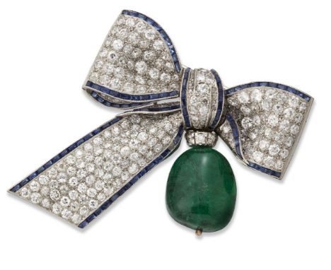 An emerald, diamond and sapphire brooch, designed as a ribbon tied bow pave set with brilliant-cut diamonds, framed with cali