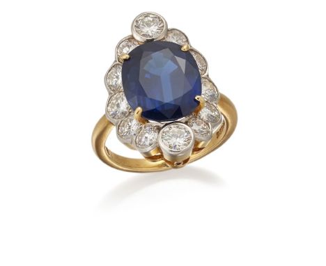 Garrard & Co, an oval sapphire and diamond cluster ring, by Garrard & Co, the claw-set oval mixed-cut sapphire weighing 6.98 