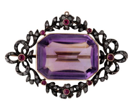 A gold, amethyst, ruby and diamond, brooch, centring on a rectangular mixed-cut buff top amethyst within a garland frame of r