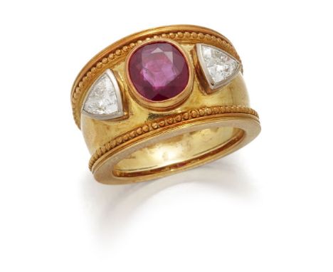 Theo Fennell, a ruby and diamond three stone ring, by Theo Fennell, the wide tapering band centring on a cushion-shaped ruby 