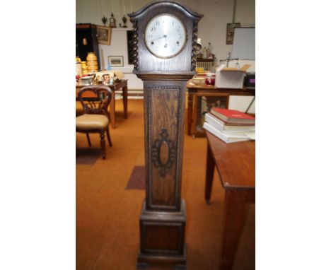 Early 20th century oak longcase clock, the hood with barley twist columns, carried on bracket feet, retail by Preston's of Bo