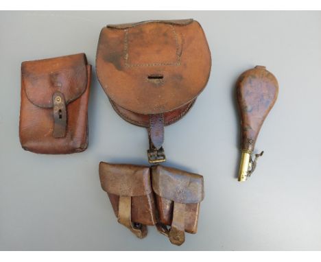 Three leather military pouches together with a horse shoe pouch dated 1943 and a shot flask with contents.