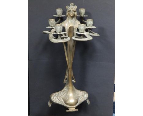 An art nouveau style brass figural multi-branch candlestick, 17" high.