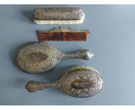 A four piece silver dressing table brush set decorated with grape vine - Walker &amp; Hall, Sheffield 1905 - comb a/f.