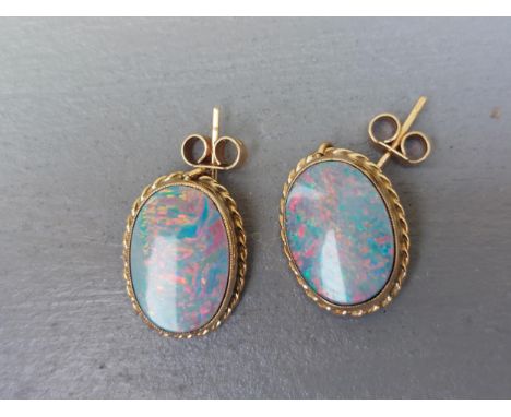 A pair of oval opal set 9ct gold drop earrings, the opals 14mm. (2)