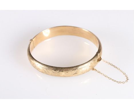 9ct gold hollow bangle with engraved decoration, 13.3g gross. 