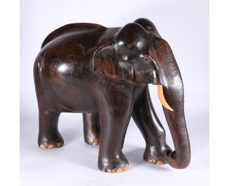 Large carved hardwood model of an elephant, 40cm tall, 47cm long.&nbsp; 