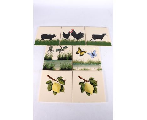 Seven Griselda Hill Wemyss pottery tiles including dragonflies, cockerels, pig, cow, lemons and butterflies, 15cm x 15cm. (7)