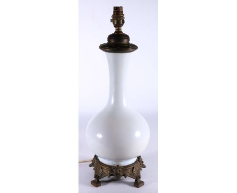 Antique baluster shaped milk glass table lamp with metal mounts, 48cm tall.&nbsp; 