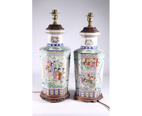 Pair of Chinese Canton famille rose converted table lamps decorated with panels of polychrome five claw dragon, figures in a 