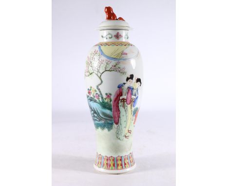 Chinese porcelain temple jar and cover, the slender baluster body decorated with figures in a garden, 31cm tall.   Lid intact