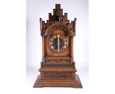 German oak cuckoo clock in architectural castle shaped case, the movement striking on a gong, 67cm tall. 