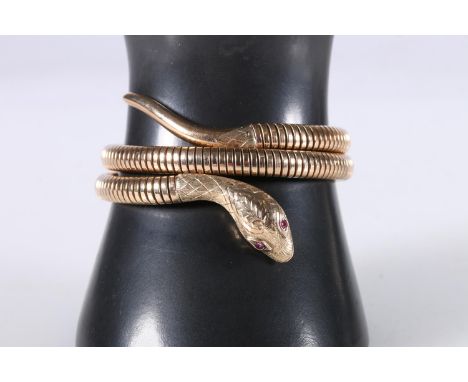 9ct gold slave bangle of serpent or snake form, rubies set to the eyes, maker Smith & Pepper Ltd, Chester 1960, 32.6g gross. 