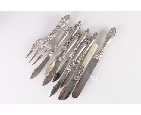 Set of six Italian 800 grade silver fish or fruit knives with mask terminals, an ornate silver trident serving fork by George