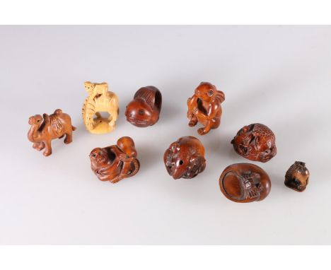 Nine carved wood netsuke including camel, monkey and octopus, rat, rabbit with carrot, crab and snail, whale, and frog. (9)  