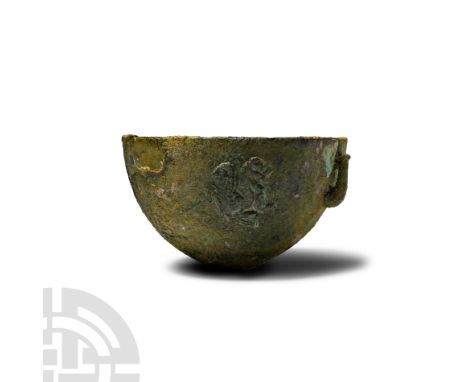 3rd millennium B.C. With D-section wall and shallow discoid foot, ornamented with a procession of three lions seated right in
