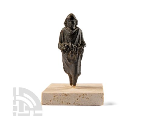 2nd-3rd century A.D.. Figure standing with left leg advanced, wearing a simple fringed robe clasped at each shoulder; tight-f