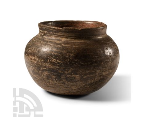 Middle Bronze Age, circa 1200-800 B.C. Squat jar with burnished surface, low rim to the neck.  450 grams, 14 cm wide (5 1/2 i
