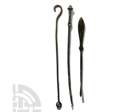 1st-4th century A.D.. Group of three implements comprising: cloak pin with conical bulb finial and piercing; hooked rod; spea