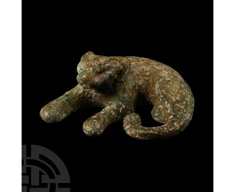 1st-3rd century A.D.. Modelled in the round laying flat on its side with forelegs extended; low-relief collar to the neck. Cf