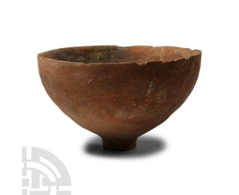 Early Bronze Age, 3rd-2nd millennium B.C. Hemispherical n profile with small foot, dimple to the underside; rim chipped.  145