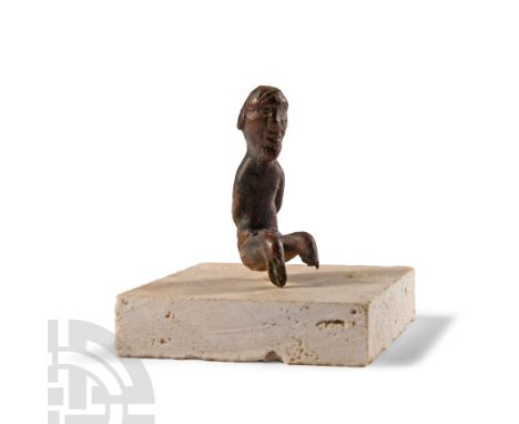 Circa 1st-2nd century A.D.. Modelled as a slender man with thick hair and beard, seated and naked with rope binding the hands