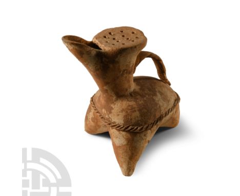 Dawenkou Culture, circa 2800-2400 B.C. Gui with three splayed tapering legs, conical spout with strainer above, applied 'rope