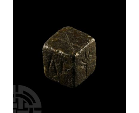 Circa 1st century A.D.. Cuboid die with five sides bearing incised symbols: ring-and-dot (or theta ?), 'IV' (for 'four'), sal