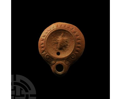 2nd century A.D.. Mould-made with convex shoulder separated from the concave discus by a narrow band of triangles and ovules,