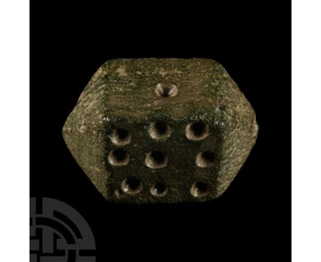 Circa 1st century A.D.. Square in section with pyramidal ends, impressed spots disposed on the flat faces: 1, 3, 6, 9. Mills,